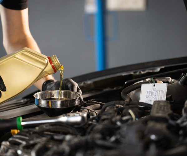 Close,Up,Of,Pouring,Fresh,New,Motor,Oil,Into,Car's